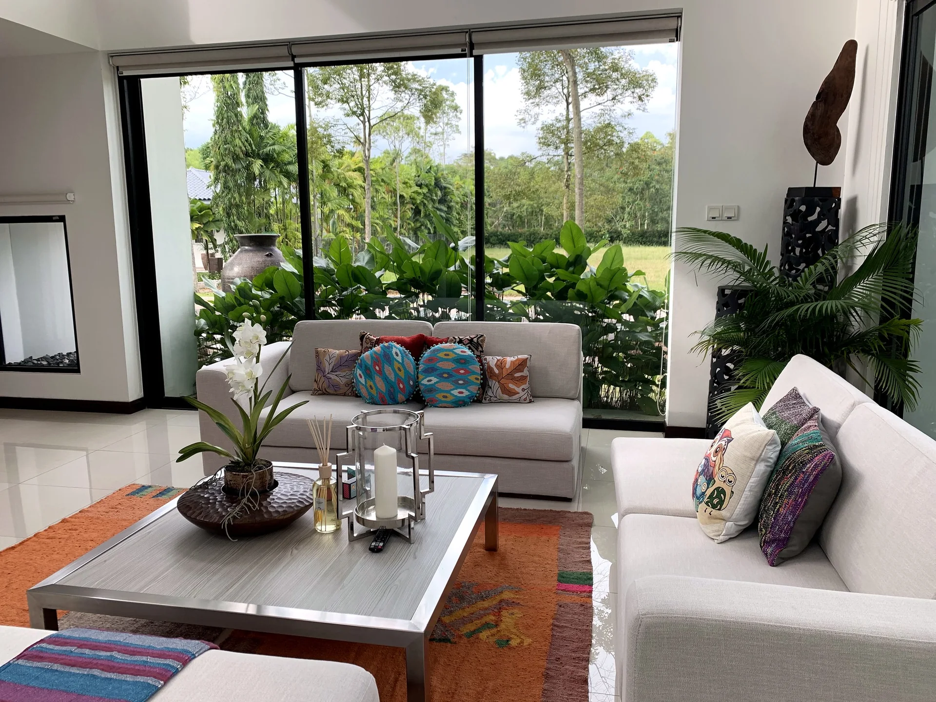 Living room opening toward a planted garden