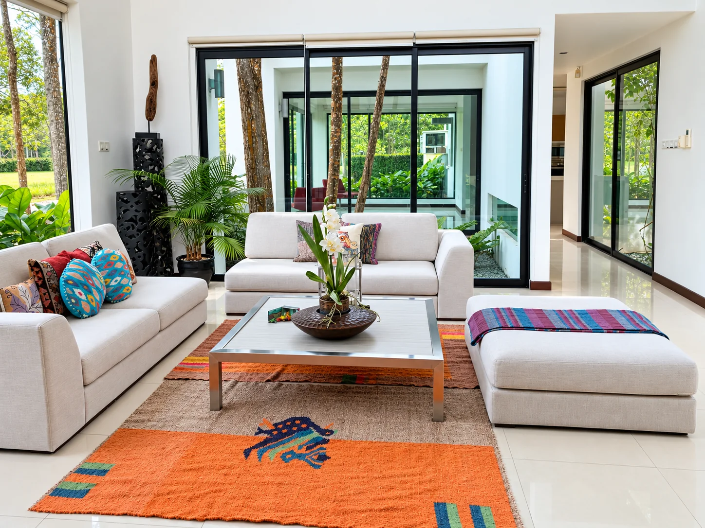 Living room with wide glazing looking toward the garden and courtyard